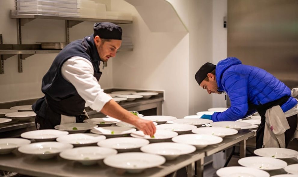 Chefs plating food in the kitchen